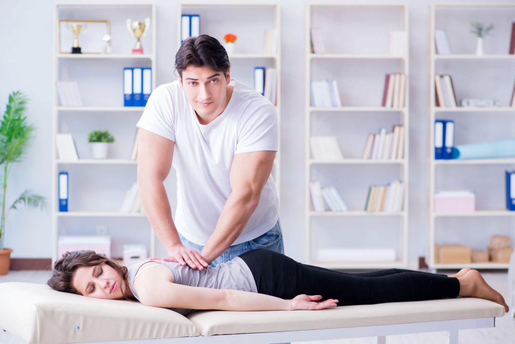 Doctor Chiropractor Massaging Patient
